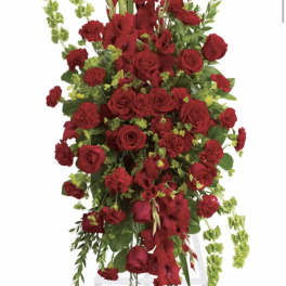 Tall red floral spray on a white easel