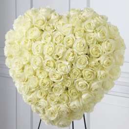 Large heart-shaped bouquet of cream roses on a stand