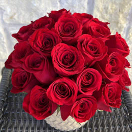 Bouquet of red roses in a white textured vase