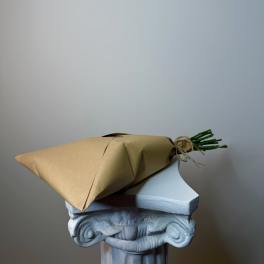 Wrapped bouquet with green stems tied in twine