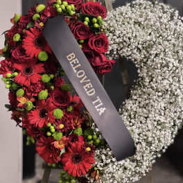 Heart-shaped floral wreath with red roses and white baby's breath