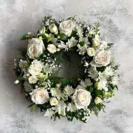 White floral wreath with roses and small white blooms