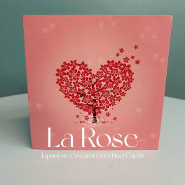 Pink greeting card with a red floral heart design and the text "La Rose"