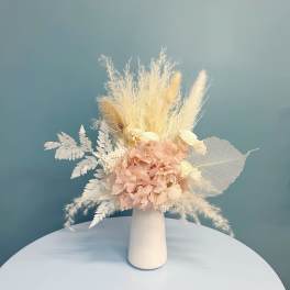 Blush dried flower arrangement in a white vase