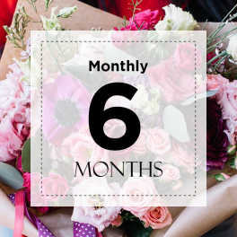 Pink and white flower bouquet with a "Monthly 6 Months" sign overlay