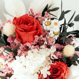 Bouquet of red roses, white flowers, and pink filler blooms