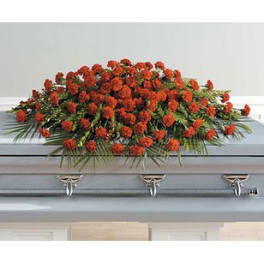 Red floral casket spray on a gray coffin