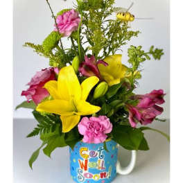 Yellow lilies and pink flowers in a mug with "Get Well Soon" text