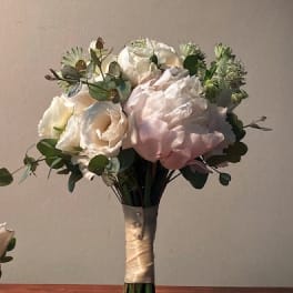 Bouquet of white and pale pink roses with eucalyptus