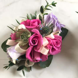 Pink and lavender rose bouquet with cream ribbon accents