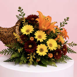 Bouquet of yellow daisies and orange lilies with a woven turkey decoration