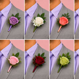 Boutonniere with a rose and greenery on a suit lapel