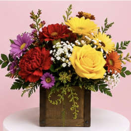 Colorful mixed flower arrangement in a wooden box