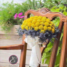Yellow pompom bouquet with blue thistle accents and white ribbon