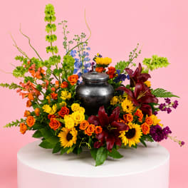 Colorful flower arrangement with a metal urn centerpiece