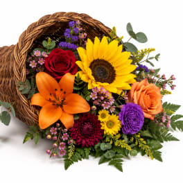 Wicker cornucopia filled with colorful mixed flowers
