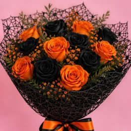 Bouquet of orange and black roses wrapped in black mesh with an orange ribbon
