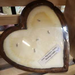 Heart-shaped candle in a wooden container