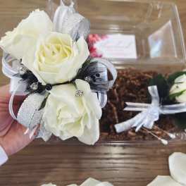 White rose corsage with silver ribbon and black accents