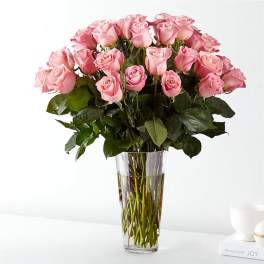 Pink roses arranged in a clear glass vase