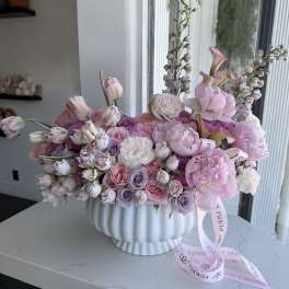 Pink and lavender bouquet in a white ribbed vase