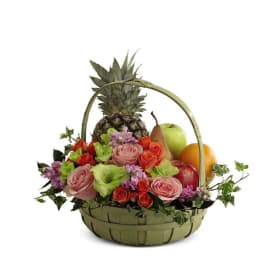 Fruit basket with roses and a pineapple in a woven basket