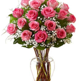 Pink roses arranged in a clear glass vase