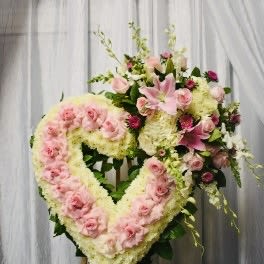 Heart-shaped floral wreath with pink roses and lilies