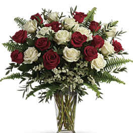 Bouquet of red and white roses in a clear glass vase