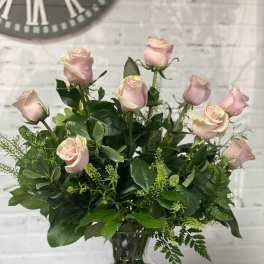 Pink roses arranged in a clear glass vase