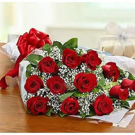 Bouquet of red roses with white filler flowers wrapped in paper