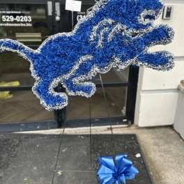 Blue and silver floral horse-shaped standing tribute on an easel