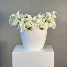 White floral arrangement in a white vase