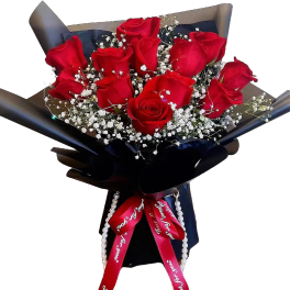 Bouquet of red roses with white baby's breath in dark wrapping