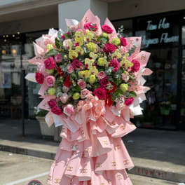 Large pink bouquet with roses and orchids on a stand