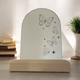 Butterfly-printed tabletop sign on a wooden base