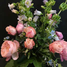 Pink roses and bell-shaped blooms in a mixed bouquet