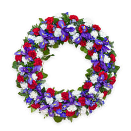 Circular wreath of red, white, and purple flowers