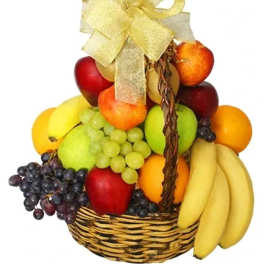 Fruit basket with apples, grapes, bananas, and oranges tied with a gold bow