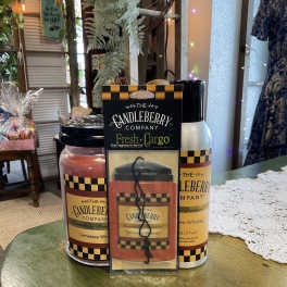 Three Candleberry Company Tennessee Whiskey candles and a car fragrance pack on a table.