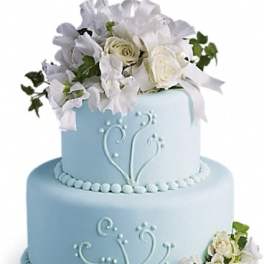 Two-tier blue cake with white floral decorations and roses