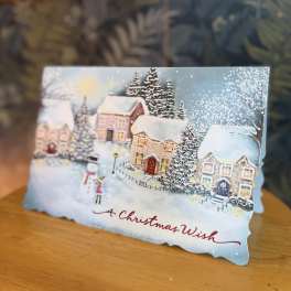 Christmas card with a snowy village scene and "A Christmas Wish" text