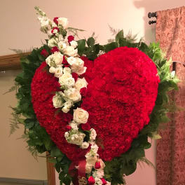 Heart-shaped red floral standing spray with white and red roses