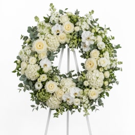 White floral wreath on a standing easel