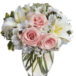 Pink roses and white lilies in a clear glass vase