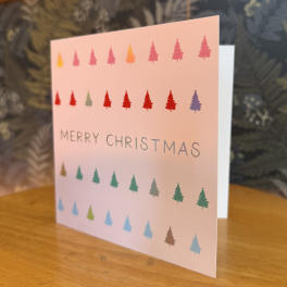 A pink Christmas card with multicolored tree icons and "Merry Christmas" text.