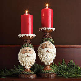 Pair of Santa candle holders with lit red candles