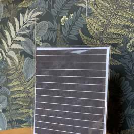 Blank striped card in a clear sleeve on a wooden table