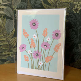 Floral greeting card with pink and orange flowers on a blue background