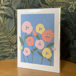 Greeting card with colorful stylized flowers in a clear sleeve